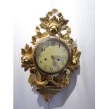 A late C19th/ early C20th Swedish gilt limewood Cartel clock with carved floral rose and swag