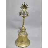 A C19th Indian brass prayer bell with three figures on the handle