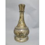 A C19th Indian hookah vase with allover incised foliate decoration, on bulbous splayed base H21.