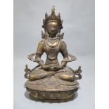 A Tibetan Bronze seated Buddhisvata Buddha in cross legged, meditative seated position, on lotus