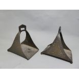 A pair of Ottoman C19th bronze stirrups, with repeating nail triangular motif