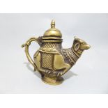 An Indian brass pot in the shape of a cow