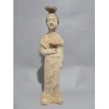 A Tang dynasty Chinese figure of a Servant Woman with some original pigment C6th-C9th