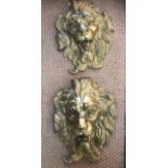 A Pair of contemporary cast iron and finely gilded exuberant lion head masks