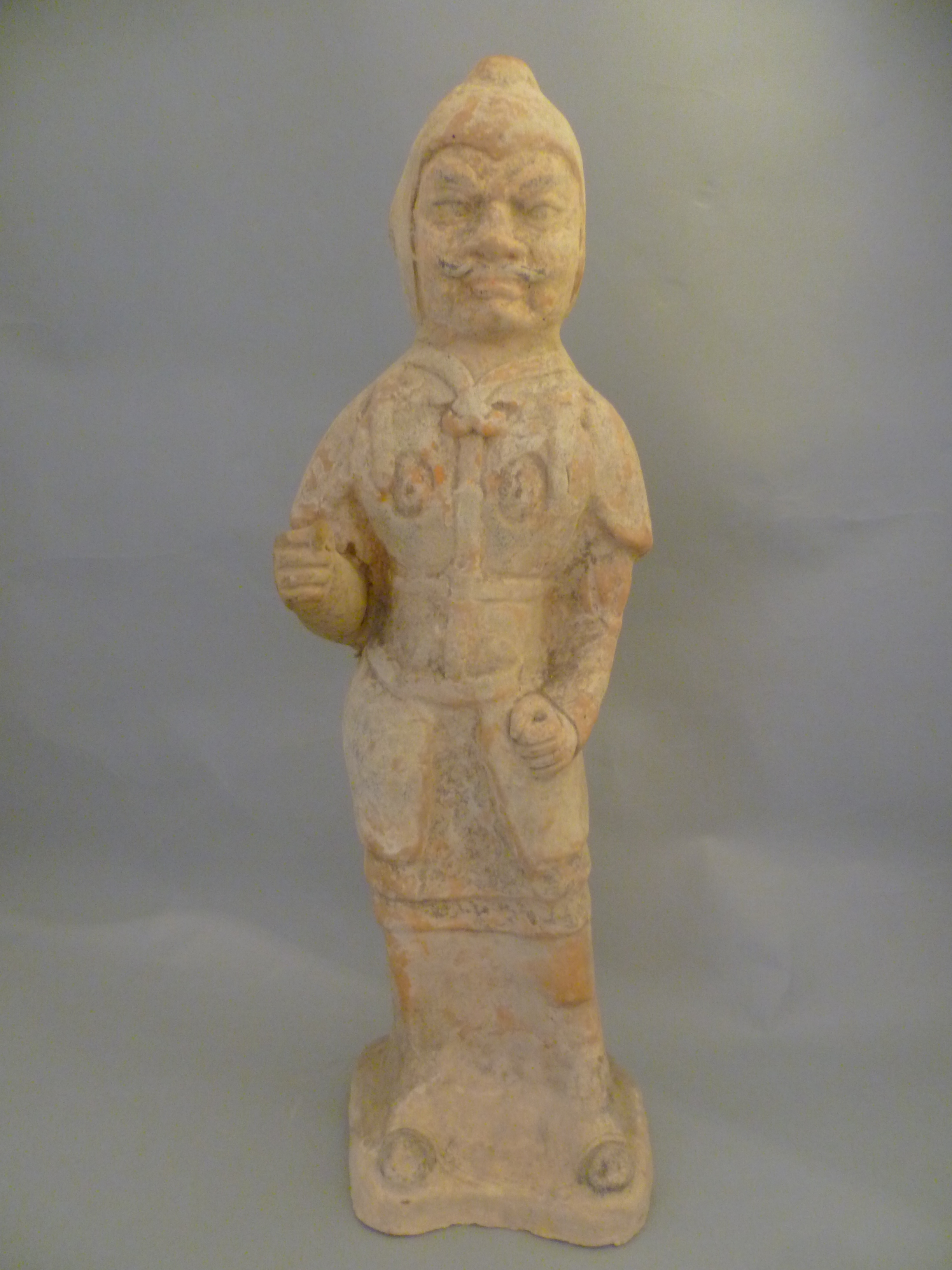 A large Tang Dynasty pottery figure of a soldier, with traces of pigment H53cm W15.5cm