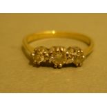 An 18ct gold engagement ring with .25 ct diamond, flanked by two further diamonds