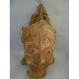 A C19th Tibetan carved wood, cloth and papier mache Buddha head with long lobes adorning crown