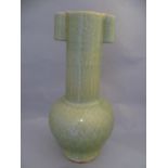 A large Chinese Qing dynasty porcelain Touhu crackle glaze vase with tubular handles, the stem