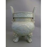 A Chinese turquoise glazed tripod censer, the two shaped handles above rim, depicting foliate and