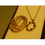 A 9ct gold round pendant with sapphire stones with chain and a diamond and sapphire swirl gold