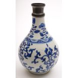 A Chinese porcelain blue and white bottle vase: painted with aster and foliate scrolls bisected by