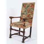 A late 17th Century carved walnut open armchair:, with a rectangular stuff over back and seat,