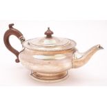 A George V silver teapot, maker William Neale & Son Ltd, Birmingham, 1925: of plain circular form,