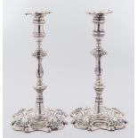 A pair of George II cast silver candlesticks, maker Richard Rugg I, London, 1757: crested,