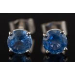 A pair of white metal and circular sapphire single stone screw back ear studs: each circular,