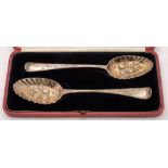 Two George III silver Hanovarian pattern and later decorated berry spoons,