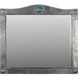 A Liberty style hammered pewter wall mirror: of arched outline with enamel boss to the central arch