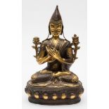 A bronze and gilt bronze Buddha: seated cross legged on a lotus stand in Dharmacakra Mudra pose