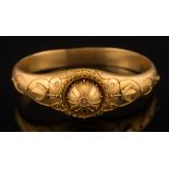 A late 19th century frosted gold hinged bangle: with applied wirework decoration in Etruscan style,