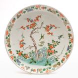 A Chinese porcelain famille rose shallow dish: of circular form enamelled with a prunus tree,