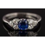 A sapphire and diamond seven stone cluster ring: with central cushion-shaped sapphire 5.