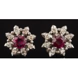 A pair of ruby and diamond circular cluster ear-studs: each with a central round ruby approximately