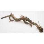 A large Japanese carved and stained ivory articulated dragon: formed from numerous overlapping