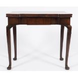 A George II mahogany tea table:, the rectangular hinged top with projecting corners,