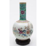 A Chinese porcelain bottle vase: enamelled in the famille rose palette with four children playing