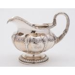 A George IV silver cream jug, maker Paul Storr, London, 1823: crested,