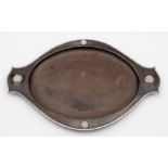 An Arts and Crafts beaten copper and silver applied tray: of oval outline,