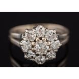 A diamond mounted circular cluster ring: with circular brilliant-cut stones estimated to weigh a