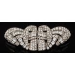 A platinum and diamond double-clip brooch: of openwork scroll design, claw,