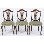 A set of four Edwardian mahogany dining chairs:, in the Hepplewhite taste,