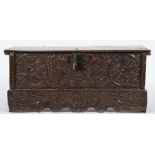 A 17th Century Continental carved oak rectangular coffer:, with a plain hinged top,