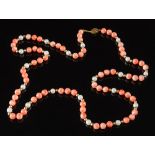 A coral bead and cultured pearl single string necklace: with beads ranging 6.5mm diameter to 7.