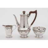 A George V hammered silver three-piece bachelor's coffee service, maker Albert Edward Jones,