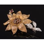 A 9ct gold, garnet and diamond mounted floral spray brooch:, approximately 12gms gross weight.