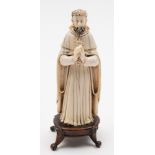 An Indo-Portugese carved and stained ivory figure of a Saint,