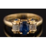 A sapphire and diamond five stone ring: the oval sapphire approximately 7mm long x 5mm wide and