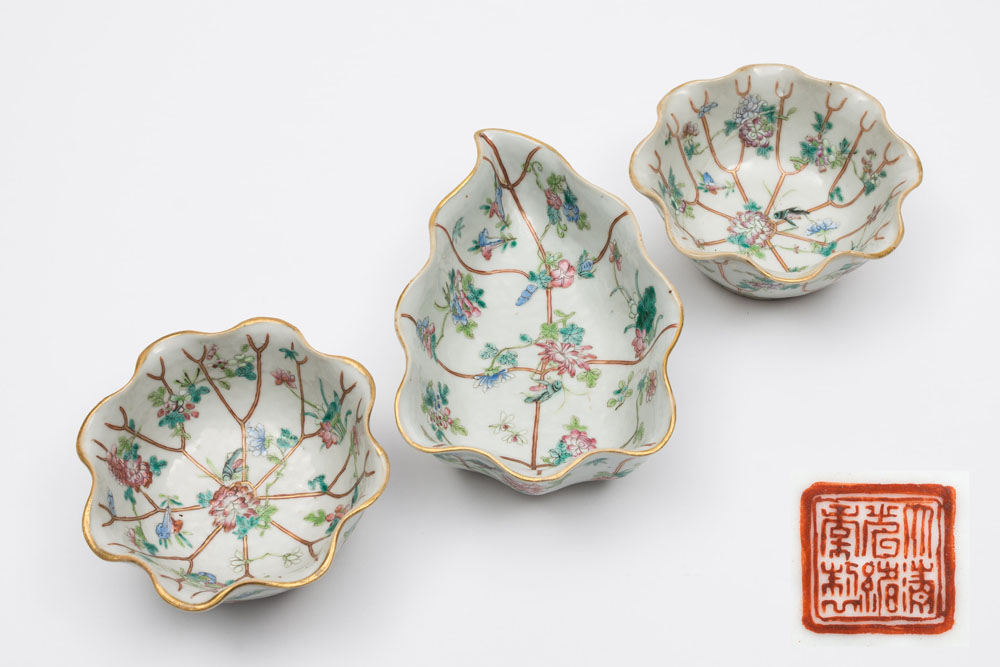 A Chinese famille rose porcelain lotus leaf shaped bowl and a pair of matching circular bowls: each