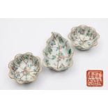 A Chinese famille rose porcelain lotus leaf shaped bowl and a pair of matching circular bowls: each