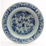 A Chinese blue and white porcelain shallow dish: the centre painted with five deer and a pair of