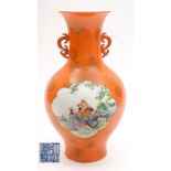 A Chinese famille rose orange ground vase: of baluster form with pierced dragon handles,