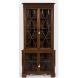 An Edwardian mahogany standing corner display cabinet:, in two parts,
