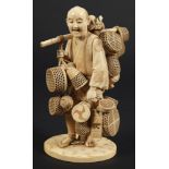 A Japanese carved ivory okimono of a basket seller: wearing traditional peasant costume with