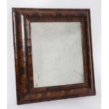 An early 18th Century walnut oyster veneer cushion frieze rectangular mirror:,