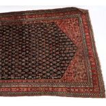 A Kashgai rug:, the indigo hexagonal field with an all over design of serated boteh medallions,