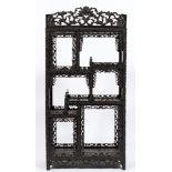 A Chinese carved ebonised hardwood open display cabinet:,