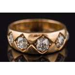 An 18ct gold and graduated diamond five stone ring: with cushion shaped diamonds estimated to weigh